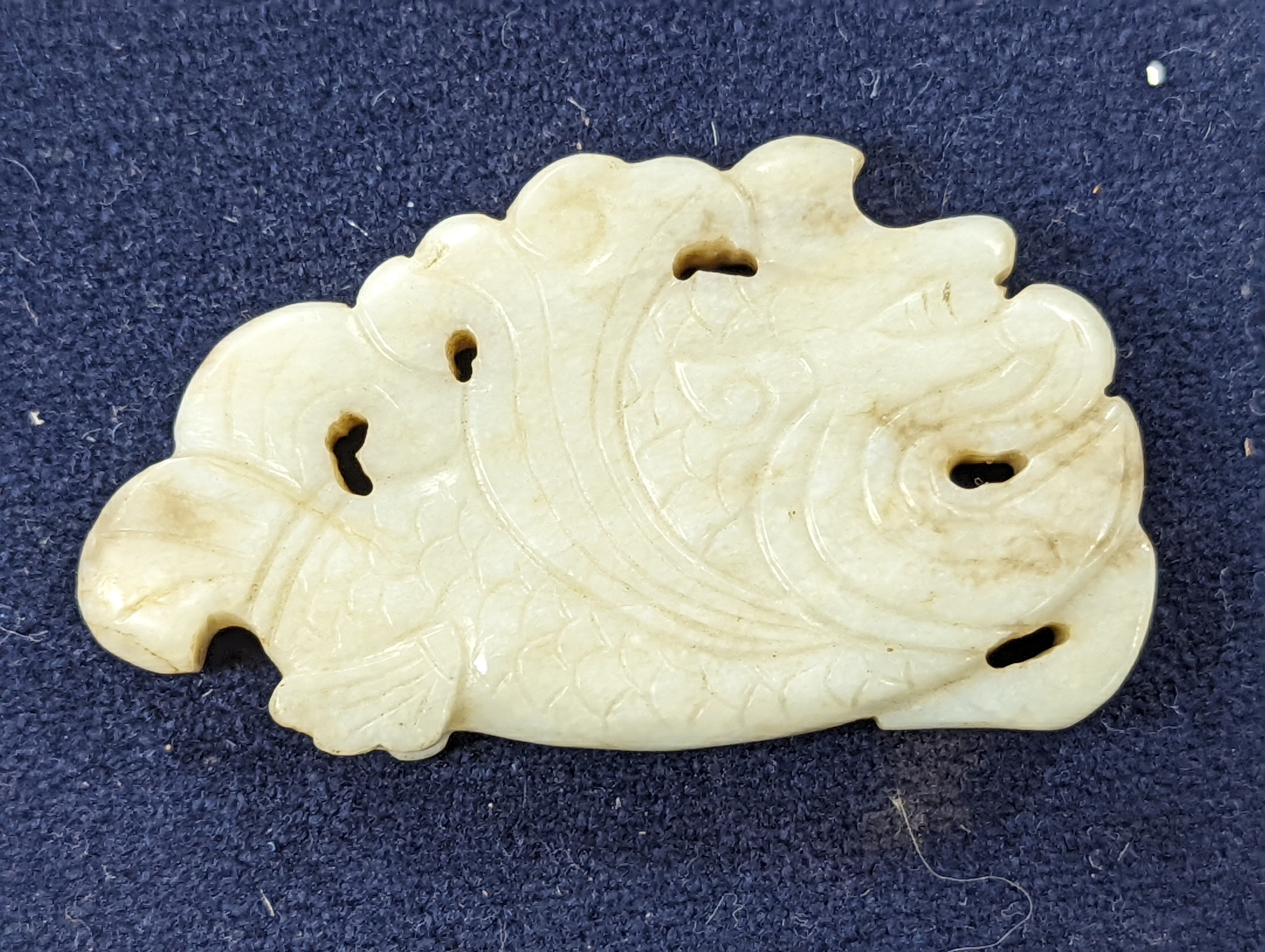 A Chinese white and black jade ‘dragon-fish’ plaque, 19th/20th century, 6cm